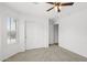 Well-lit bedroom with a ceiling fan, closet, and a large window at 4404 W Ellis St, Laveen, AZ 85339