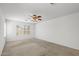 Bright bedroom featuring neutral walls, plush carpet, and plantation shutters at 4404 W Ellis St, Laveen, AZ 85339