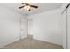 Neutral bedroom with a ceiling fan, closet, and an entrance to another room at 4404 W Ellis St, Laveen, AZ 85339