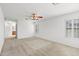 Cozy bedroom featuring plush carpet, neutral walls, ceiling fan, and large windows at 4404 W Ellis St, Laveen, AZ 85339