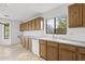 The kitchen features wood cabinets, white appliances, and a sink with a window view at 4404 W Ellis St, Laveen, AZ 85339