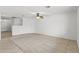 Large living area with neutral carpet and tile flooring, a ceiling fan, and seamless access to other rooms at 4404 W Ellis St, Laveen, AZ 85339