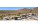Aerial view of homes in a desert community, showcasing beautiful landscaping and mountain views at 4562 S Alamos Way, Gold Canyon, AZ 85118