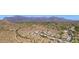 Aerial view of a desert community with mountain views and mature landscaping at 4562 S Alamos Way, Gold Canyon, AZ 85118
