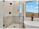 A bathroom features a free-standing tub and walk-in shower with neutral tile and black hardware at 4562 S Alamos Way, Gold Canyon, AZ 85118