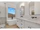 Bright bathroom features dual sinks, modern vanity, and free-standing soaking tub at 4562 S Alamos Way, Gold Canyon, AZ 85118