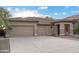 Charming single-story home featuring a three-car garage and a decorative fountain at 4562 S Alamos Way, Gold Canyon, AZ 85118