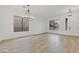 Open-concept living room filled with natural light and featuring modern light fixtures at 4562 S Alamos Way, Gold Canyon, AZ 85118