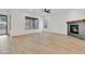 Bright living room with a fireplace, wood floors and large windows, offers a comfortable and modern space at 4562 S Alamos Way, Gold Canyon, AZ 85118