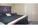 Spacious main bedroom with a dark wood bed frame and plush bedding at 4718 W Sanna St, Glendale, AZ 85302