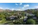 Expansive estate with mature landscaping, a tennis court, and mountain views on a sunny day at 4801 E Horseshoe Rd, Paradise Valley, AZ 85253