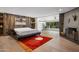 Modern bedroom featuring unique wood wall and fireplace, creating a cozy and stylish retreat at 4801 E Horseshoe Rd, Paradise Valley, AZ 85253