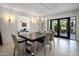 Elegant dining room with modern table, stylish chairs, and large glass doors at 4801 E Horseshoe Rd, Paradise Valley, AZ 85253