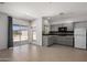 An open kitchen with gray cabinets, tile backsplash, and stainless steel appliances at 4801 E Horseshoe Rd, Paradise Valley, AZ 85253