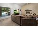 Inviting living room featuring a stone fireplace and a large window with a view to the outside pool at 4801 E Horseshoe Rd, Paradise Valley, AZ 85253