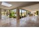 Spacious outdoor patio featuring a built-in grill and beautiful views of the landscaped backyard and pool at 4801 E Horseshoe Rd, Paradise Valley, AZ 85253