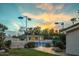 Outdoor tennis court surrounded by mature landscaping and enhanced with overhead lighting at 4801 E Horseshoe Rd, Paradise Valley, AZ 85253