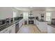 Bright kitchen with stainless steel appliances, white cabinets, dark counters, and plenty of natural light at 520 S Macdonald --, Mesa, AZ 85210
