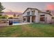 Stunning backyard features a pool, lush green lawn, and covered patio, perfect for outdoor living and entertaining at 521 N Cambridge St, Gilbert, AZ 85233