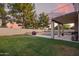 This backyard has a beautiful pool, lush lawn and an outdoor kitchen area for easy and fun entertaining at 521 N Cambridge St, Gilbert, AZ 85233