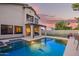 Gorgeous backyard with a sparkling pool, patio, and lush landscaping, offering a perfect oasis for outdoor enjoyment at 521 N Cambridge St, Gilbert, AZ 85233