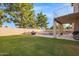 Enjoy this backyard, complete with a pool, an outdoor kitchen, lots of lush lawn and a private backyard at 521 N Cambridge St, Gilbert, AZ 85233