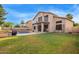 Beautiful backyard features a pool, lush green lawn, and outdoor kitchen, perfect for relaxation and entertainment at 521 N Cambridge St, Gilbert, AZ 85233