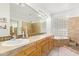 Spacious bathroom with dual sinks, walk-in shower, and soaking tub at 521 N Cambridge St, Gilbert, AZ 85233