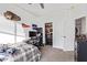 This bedroom features decor, neutral carpet, a ceiling fan, and a closet at 521 N Cambridge St, Gilbert, AZ 85233