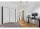 Bedroom with a large closet, hardwood floors, and a ceiling fan at 521 N Cambridge St, Gilbert, AZ 85233