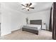 Neutral bedroom with a ceiling fan, carpet flooring, and a gray upholstered bed at 521 N Cambridge St, Gilbert, AZ 85233