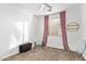 Cozy bedroom with natural light streaming through the blinds and pink curtains at 521 N Cambridge St, Gilbert, AZ 85233