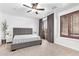 Bright, neutral bedroom featuring a ceiling fan and slider access to an outdoor space at 521 N Cambridge St, Gilbert, AZ 85233