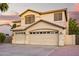 Inviting two-story home with a three-car garage and a well-maintained desert landscape at 521 N Cambridge St, Gilbert, AZ 85233