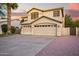 Inviting two-story home with a three-car garage and a well-maintained desert landscape at 521 N Cambridge St, Gilbert, AZ 85233