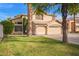 Beautiful two-story home with green lawn and a convenient three-car garage at 521 N Cambridge St, Gilbert, AZ 85233