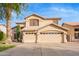 Lovely two-story home boasts a three-car garage and a neatly kept front yard at 521 N Cambridge St, Gilbert, AZ 85233