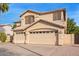 Beautiful two-story home with a three-car garage, desert landscaping, and a tile roof at 521 N Cambridge St, Gilbert, AZ 85233