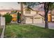 Charming two-story home with a well-manicured lawn and an attached three-car garage at 521 N Cambridge St, Gilbert, AZ 85233