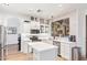 Bright kitchen featuring white cabinetry, stainless steel appliances, and an island with counter seating at 521 N Cambridge St, Gilbert, AZ 85233