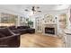 Cozy living room featuring a fireplace, wood floors, and ample natural light at 521 N Cambridge St, Gilbert, AZ 85233
