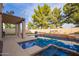 Backyard view of a refreshing pool with a charming patio and lush green landscape at 521 N Cambridge St, Gilbert, AZ 85233