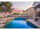 Sparkling pool surrounded by a patio and lush greenery, creating a serene oasis for relaxation and enjoyment at 521 N Cambridge St, Gilbert, AZ 85233