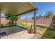 Cozy covered patio with string lights and a spacious backyard, perfect for outdoor entertaining at 619 E Jensen St # 34, Mesa, AZ 85203