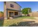 A home's backyard featuring a covered patio, lawn, and mature landscaping that enhances outdoor living at 619 E Jensen St # 34, Mesa, AZ 85203