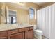 Bathroom featuring a wood vanity, large mirror, and shower/tub combo at 619 E Jensen St # 34, Mesa, AZ 85203