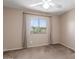 This bedroom is carpeted and has a window with a desert landscape view at 619 E Jensen St # 34, Mesa, AZ 85203