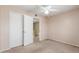 This bedroom is carpeted and has a closet and ceiling fan with light fixture at 619 E Jensen St # 34, Mesa, AZ 85203