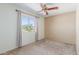 This carpeted bedroom features a window with a desert view and a ceiling fan at 619 E Jensen St # 34, Mesa, AZ 85203