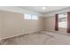 Spacious bedroom offers neutral walls, carpet flooring and a large window at 619 E Jensen St # 34, Mesa, AZ 85203